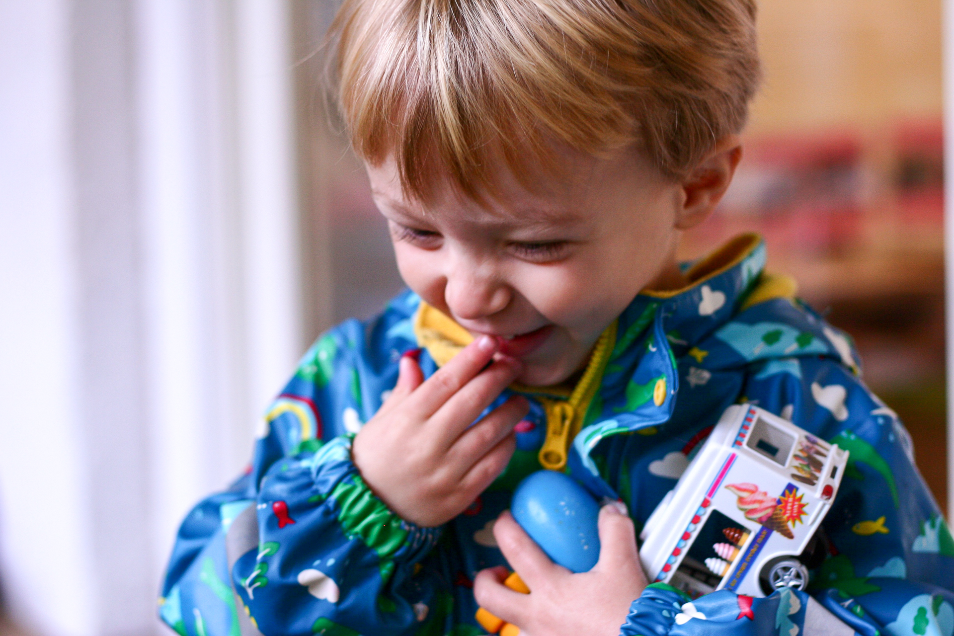 Toddler playing with toys laughing